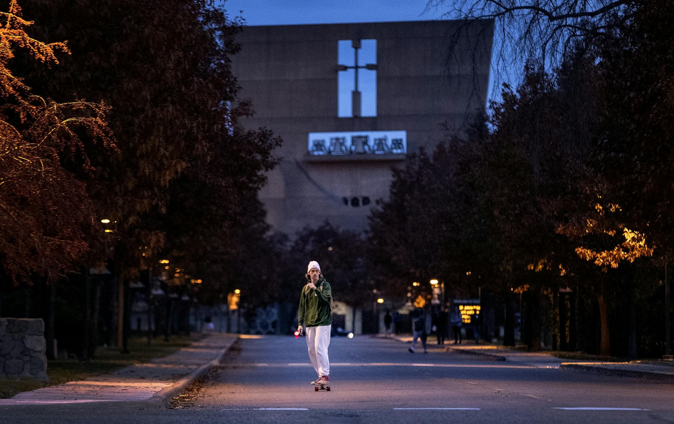 St. John's quarterback Jackson Erdmann rode his skateboard on campus after practice.