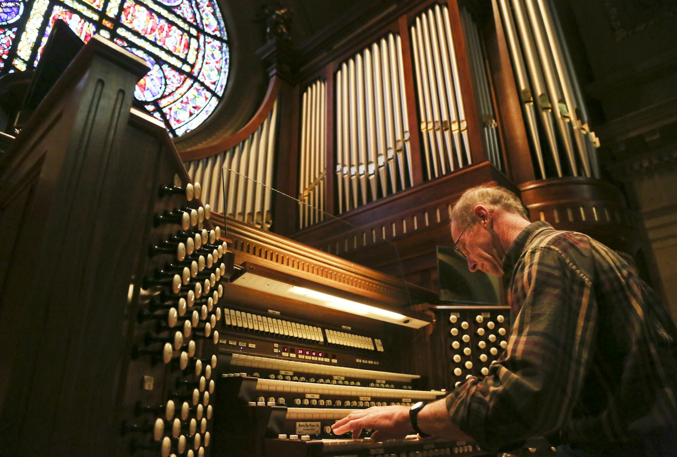 Eric Johnson of Quimby Pipe Organs fine-tuned one of the two refurbished pipe organs at the Cathedral of St. Paul on Wednesday.