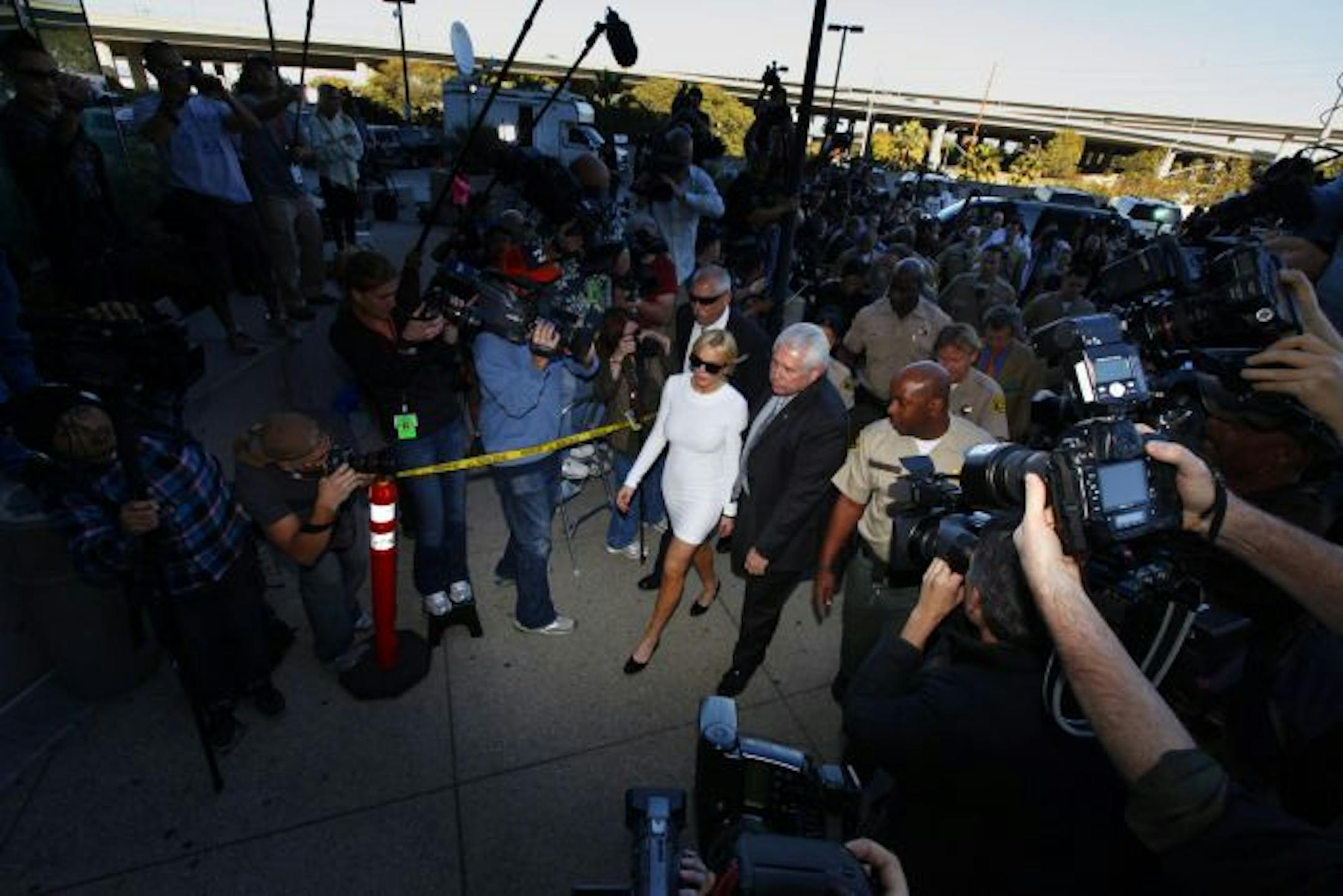 Actress Lindsay Lohan, above, was criticized for wearing a form-fitting white dress to her hearing on felony grand-theft charges last month in California.