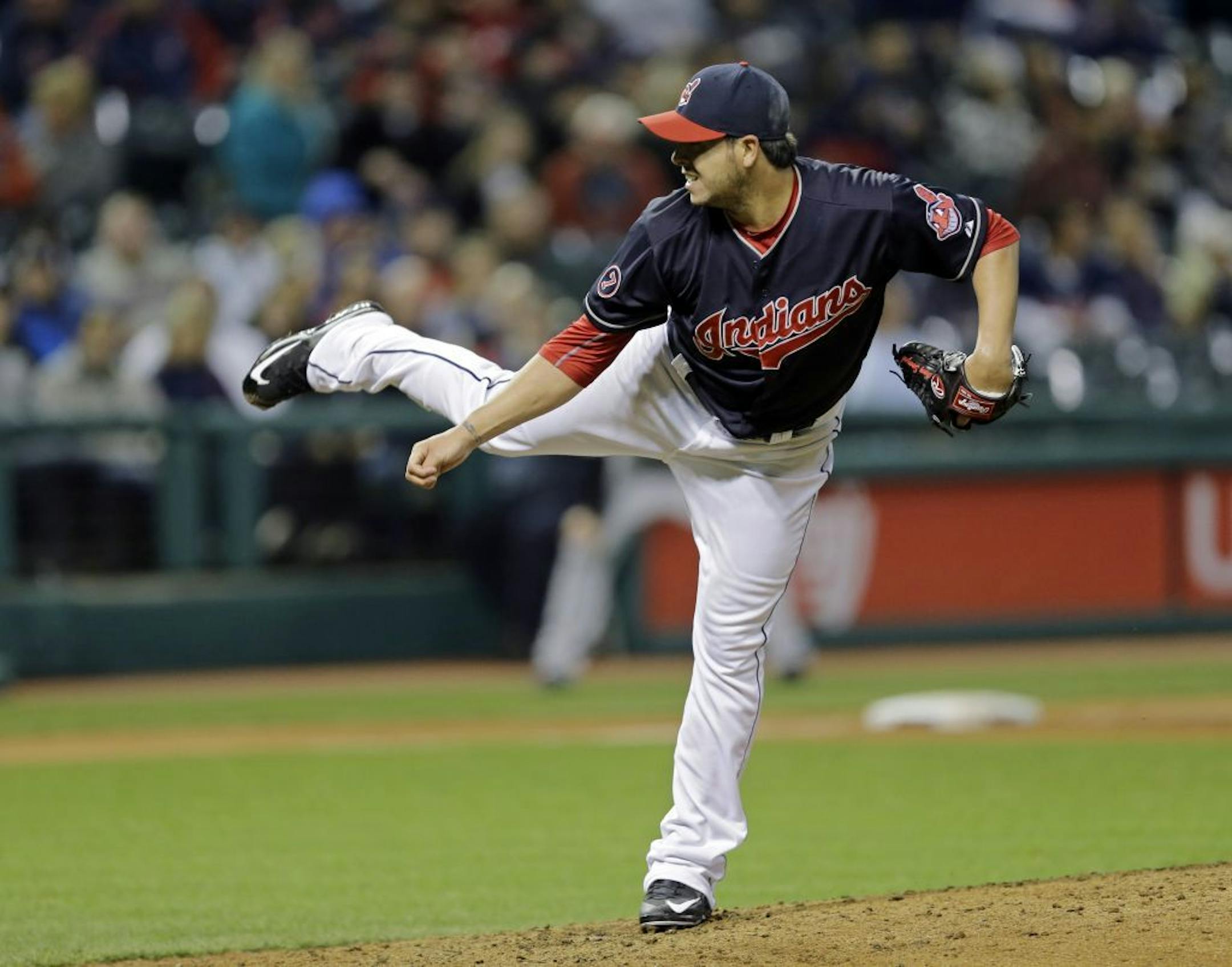 Cleveland Indians' Anthony Swarzak follows through on a pitch against the Chicago White Sox in the sixth inning of a baseball game Tuesday, April 14, 2015, in Cleveland.