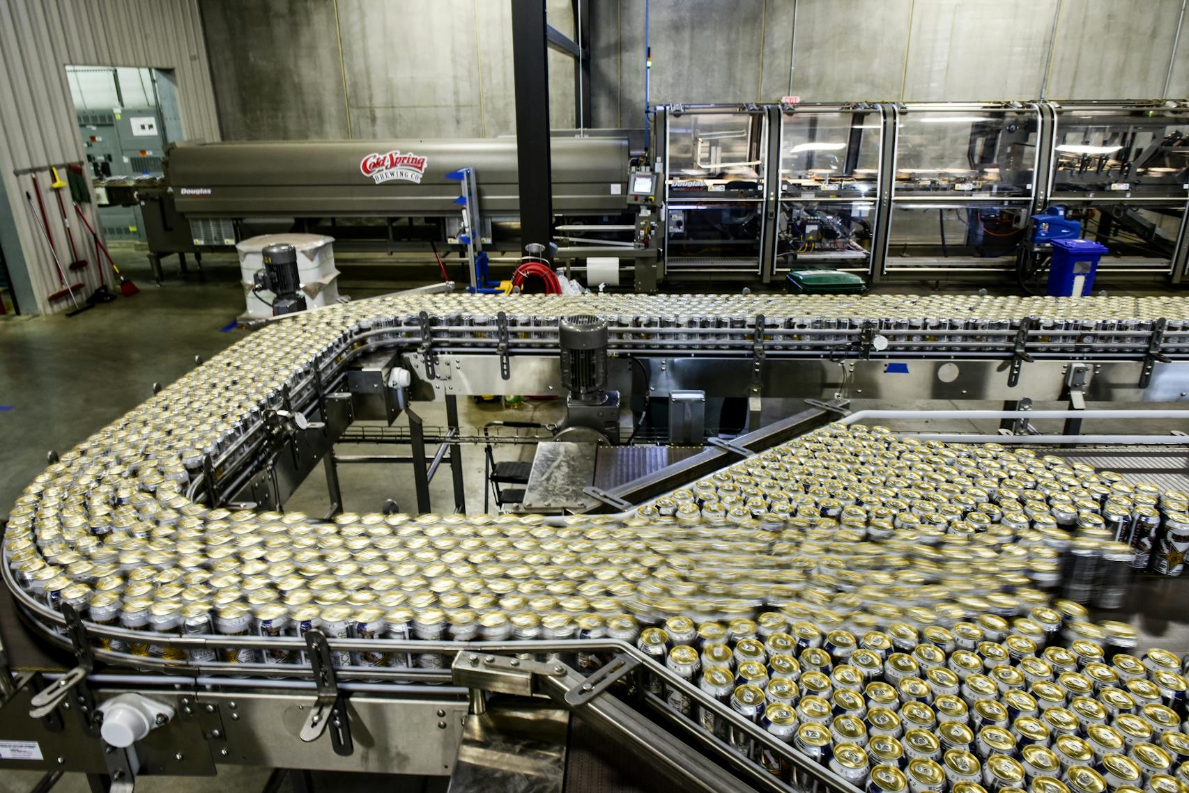 Cans of Rockstar energy drink moved along the production line at Cold Spring Brewing's new facility.