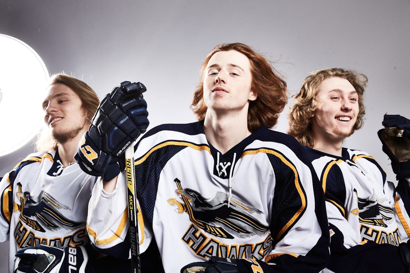 Members of the Hermantown Hawks, featured on ESPN next week, show off their hockey hair.