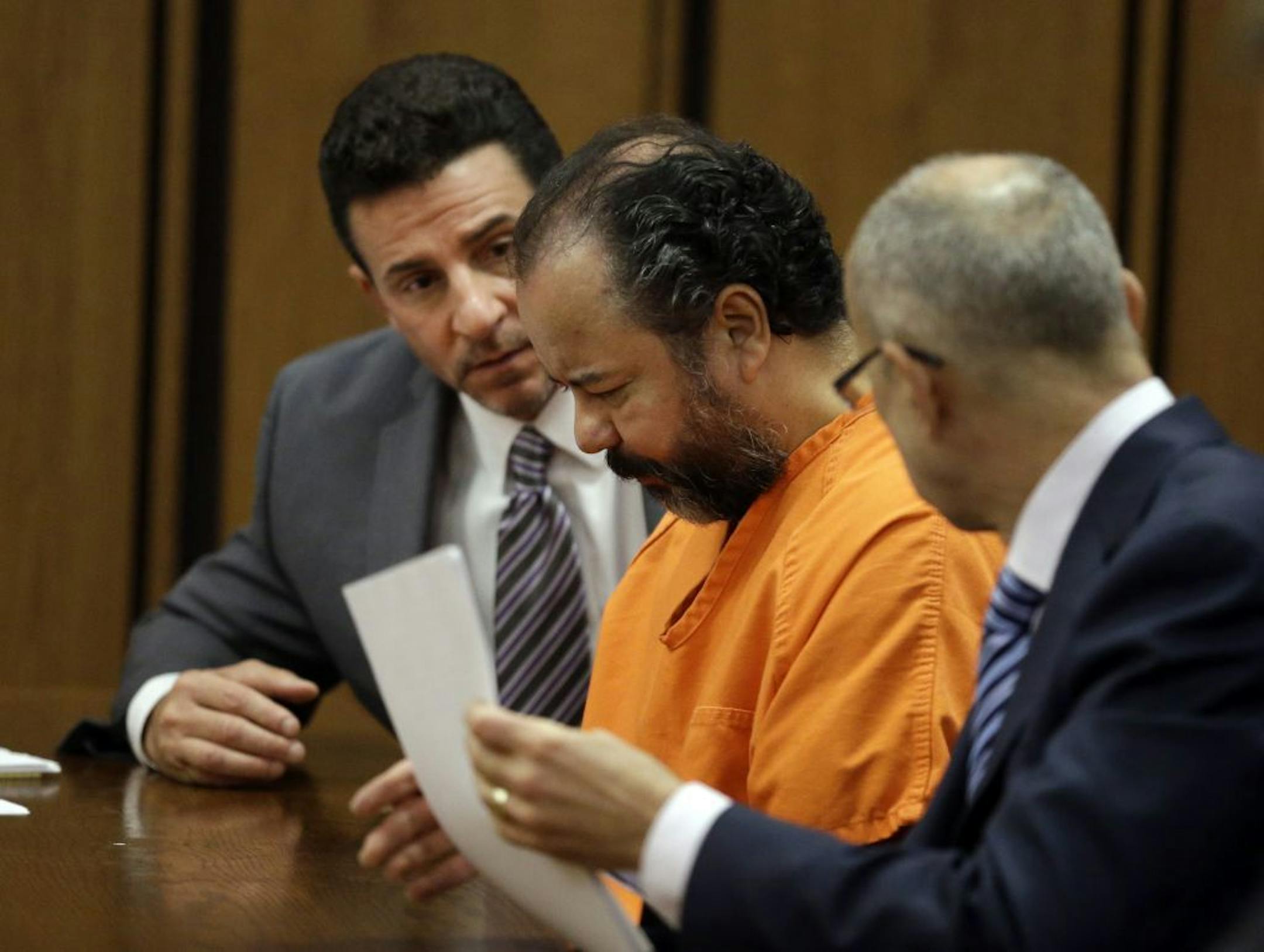 Ariel Castro, center, confers with his attorneys Craig Weintraub, left, and Jaye Schlachet during a pretrial hearing in Cuyahoga County Common Pleas Court in Cleveland, Wednesday, July 3, 2013.