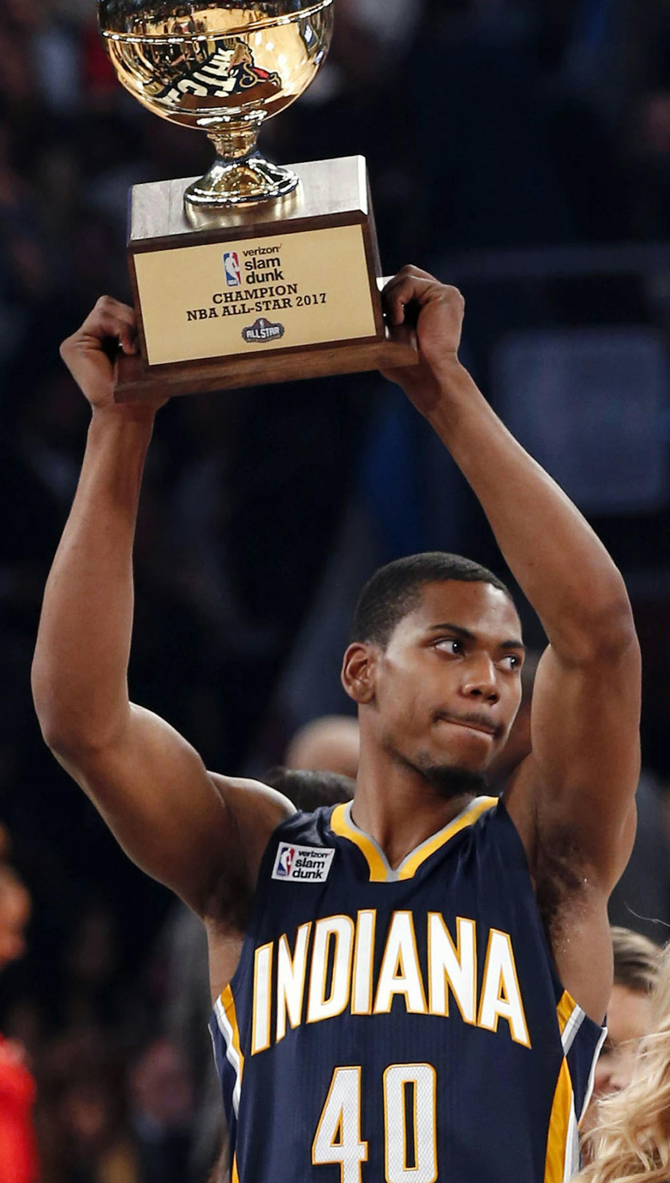 Indiana Pacers Glenn Robinson III holds up his trophy after winning the slam dunk contest during NBA All-Star Saturday Night events in New Orleans, Saturday, Feb. 18, 2017. (AP Photo/Gerald Herbert)