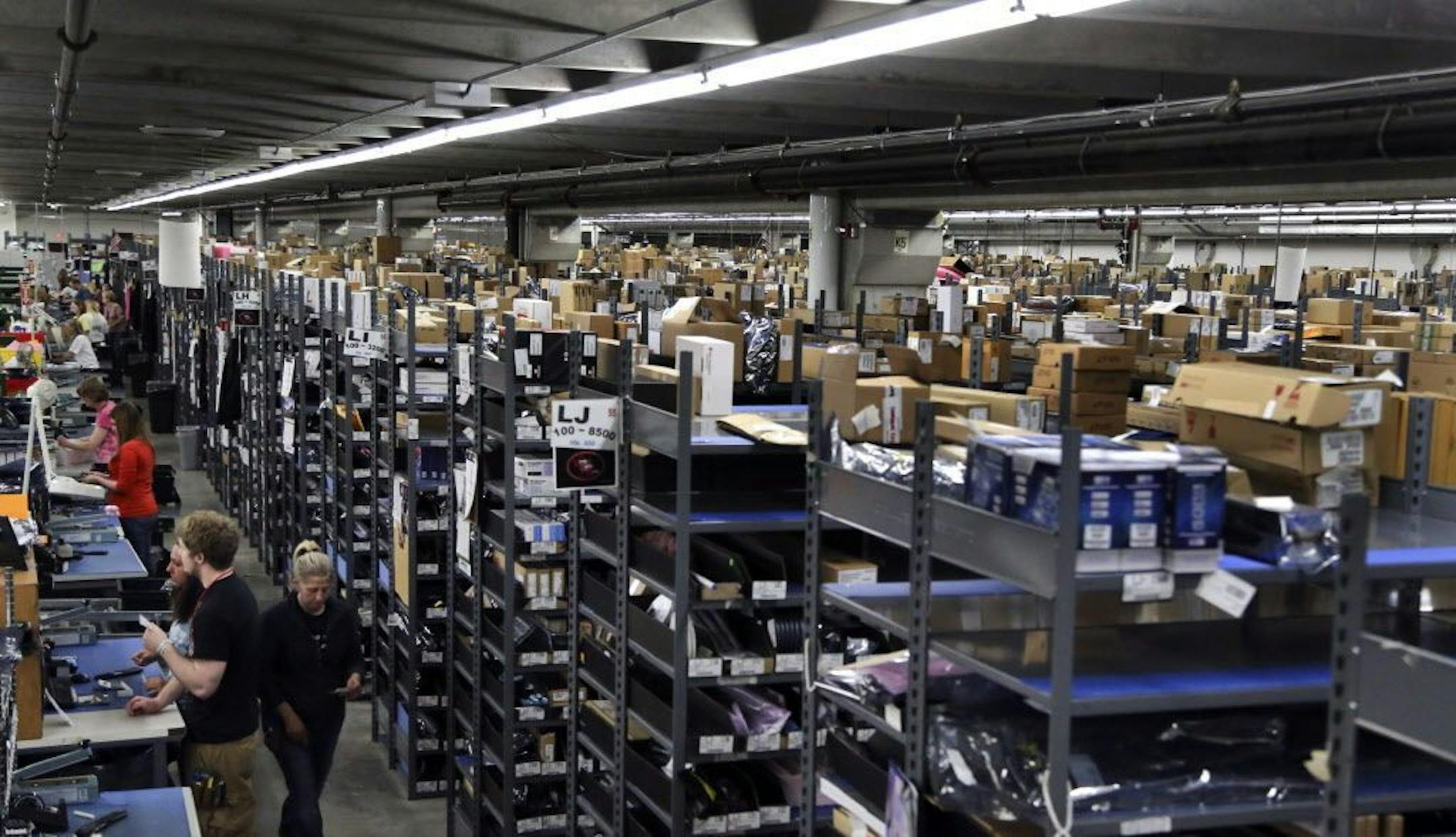 Digi-Key pickers line the warehouse floor Tuesday, May 14, 2013 in Thief River Falls, MN. With projected sales of $1.6 billion in 2013 and 840,000 parts on the shelf it its vast inventory, Digi-Key is among the world's heavy weights in internet electronics parts firms.