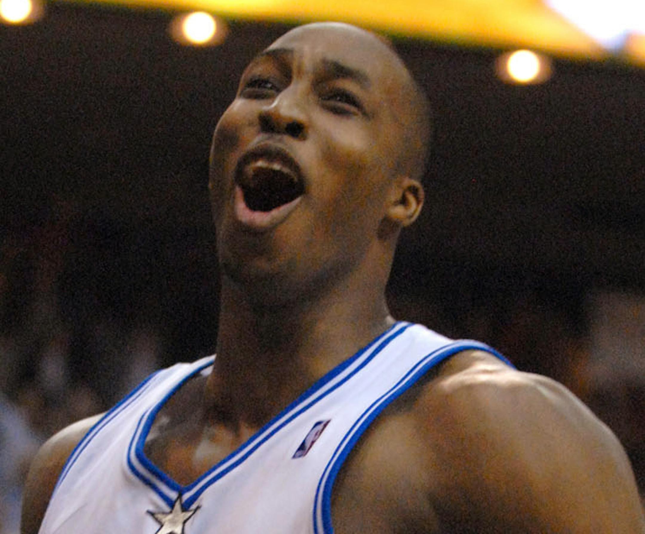 Orlando Magic center Dwight Howard celebrates after his dunk against the San Antonio Spurs during the final second of an NBA basketball game in Orlando, Fla., Friday, Feb. 9, 2007. The Magic won 106-104. (AP Photo/Phelan M. Ebenhack) ORG XMIT: DOA110