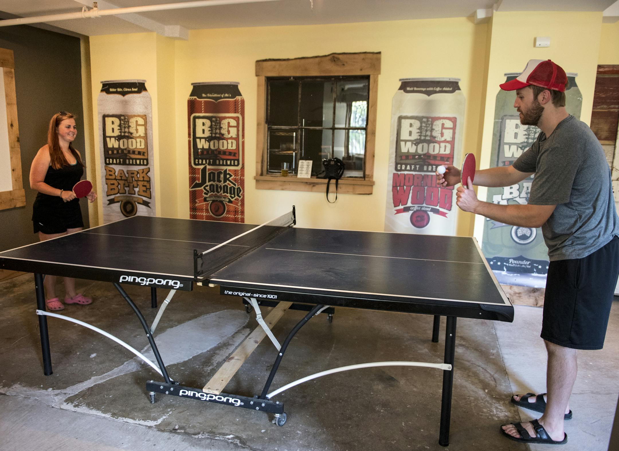Hannah Hoffman and Justin Munson, both from Hastings, played ping pong in Big Wood Brewery's tap room during their first visit to the brewery Saturday. ] (AARON LAVINSKY/STAR TRIBUNE) aaron.lavinsky@startribune.com Photos to accompany a feature on craft beer taprooms. Photographed Saturday, June 25, 2016 in White Bear Lake and Lino Lakes.