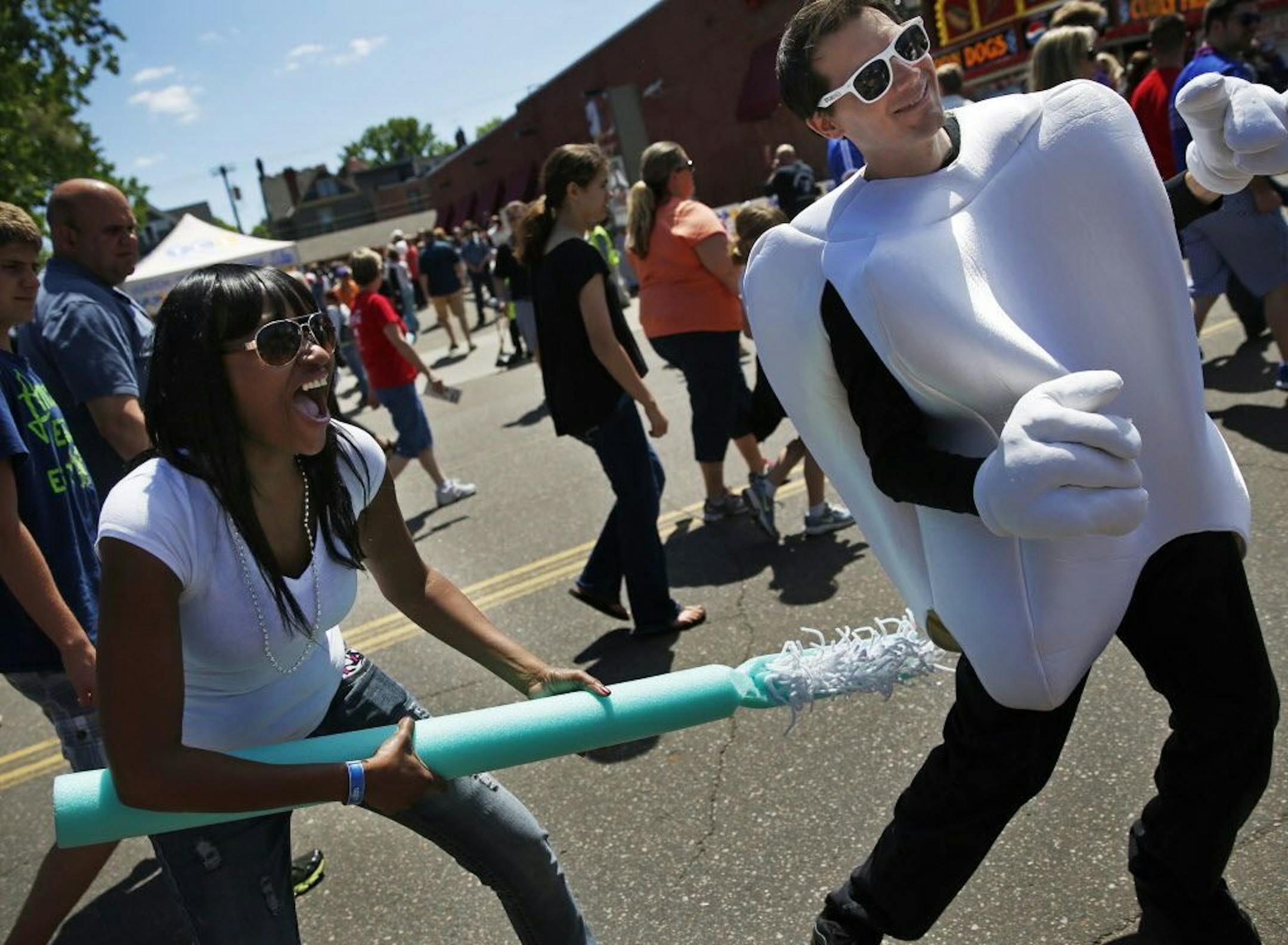At the 40th annual Grand Old Day in St. Paul, a crowd of over 250,000 people were in attendance. Tiffany Bentford of Lichtfield gave Jay Schlie a brushup. Schlie was promoting Project Healthy Smile which helps bring dental supplies to third world countries.