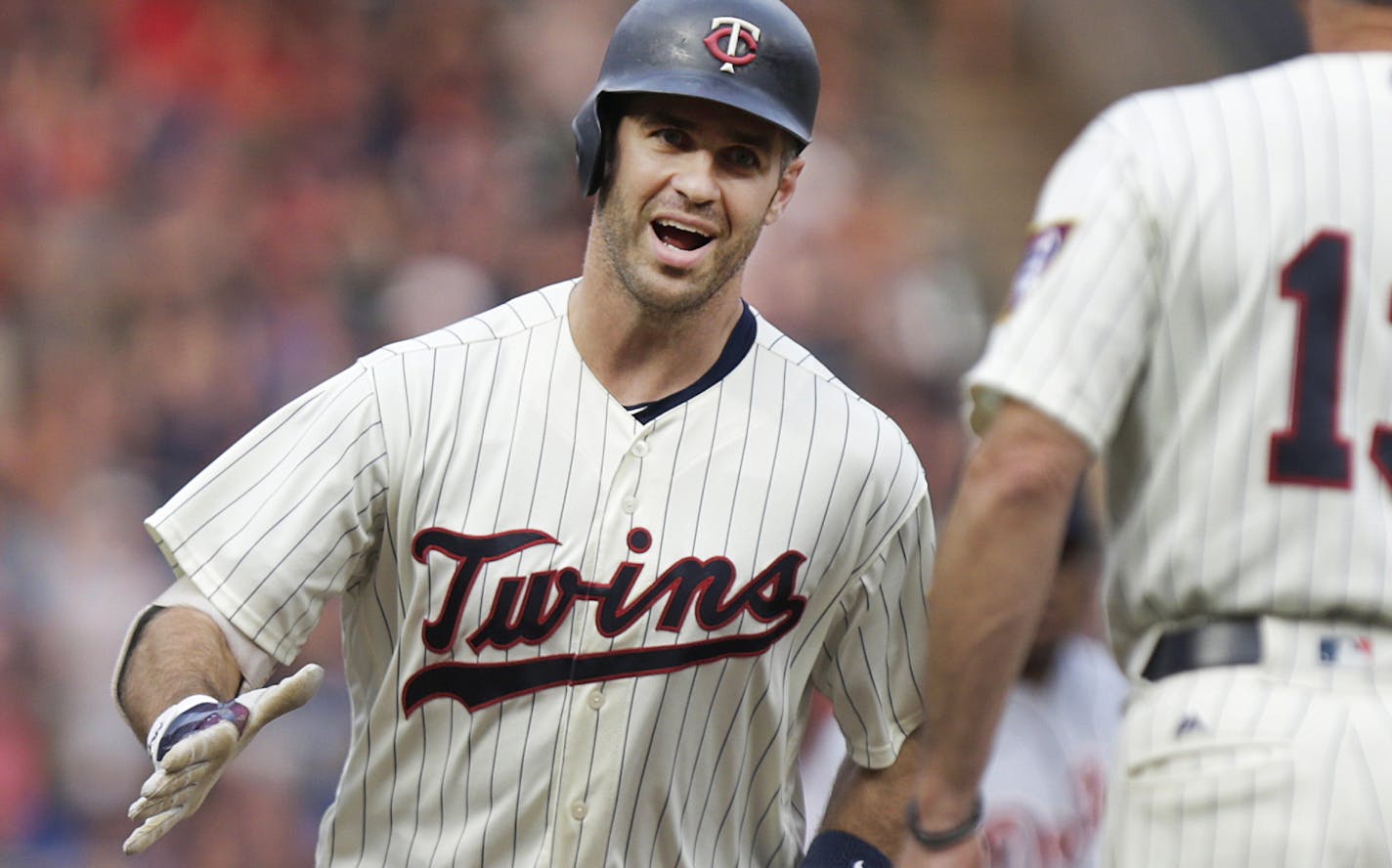 Minnesota Twins' Joe Mauer celebrates his home run with third base coach Gene Glynn against the Detroit Tigers in the first inning during a baseball game Saturday, Aug. 18, 2018, in Minneapolis. (AP Photo/Andy Clayton-King)