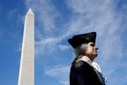 John Lopes, playing the part of President George Washington, stood near the Washington Monument in 2019 in Washington, D.C.