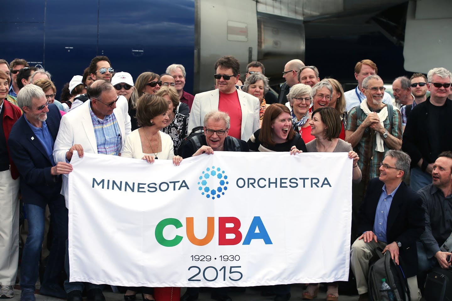 Members of the Minnesota Orchestra group pose for a group photo in front of their plane upon arrival at Jose Marti International Airport in Havana, Cuba on Wednesday.