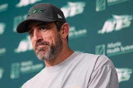 Jets quarterback Aaron Rodgers talks to reporters after a practice on May 21.