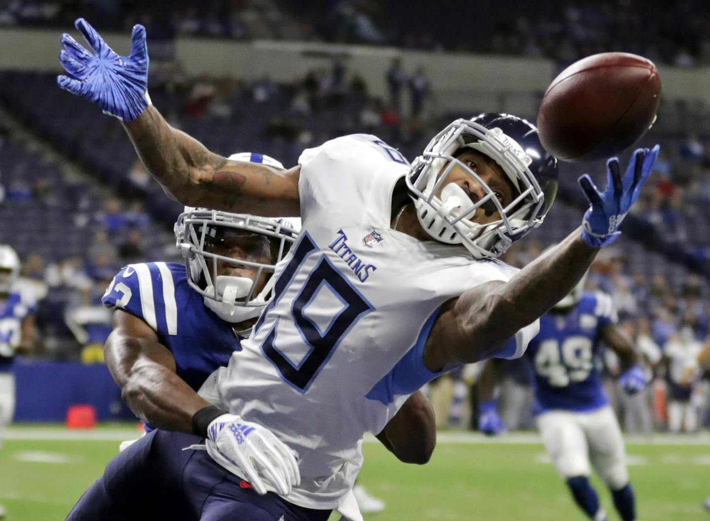 FILE - In this Nov. 18, 2018, file photo, Tennessee Titans' Tajae Sharpe (19) makes a touchdown catch against Indianapolis Colts' Kenny Moore during the second half of an NFL football gam, in Indianapolis. After the departure of Stefon Diggs, the Vikings have turned to Sharpe to fill a startling void at wide receiver. (AP Photo/Michael Conroy, File) ORG XMIT: NYDD218