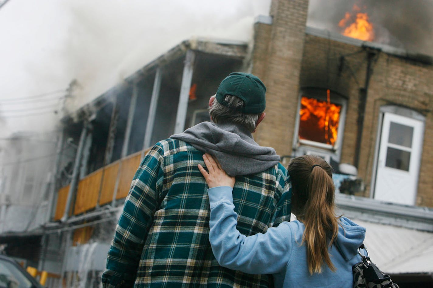 In April 2010, a blaze killed six people in apartments over what was McMahon's Irish Pub at E. Lake Street and 30th Avenue S. A cause was never nailed down. Here, Richard Otken watched his apartment burn and was comforted by Kursten Dahl, who worked as a server at McMahon's.