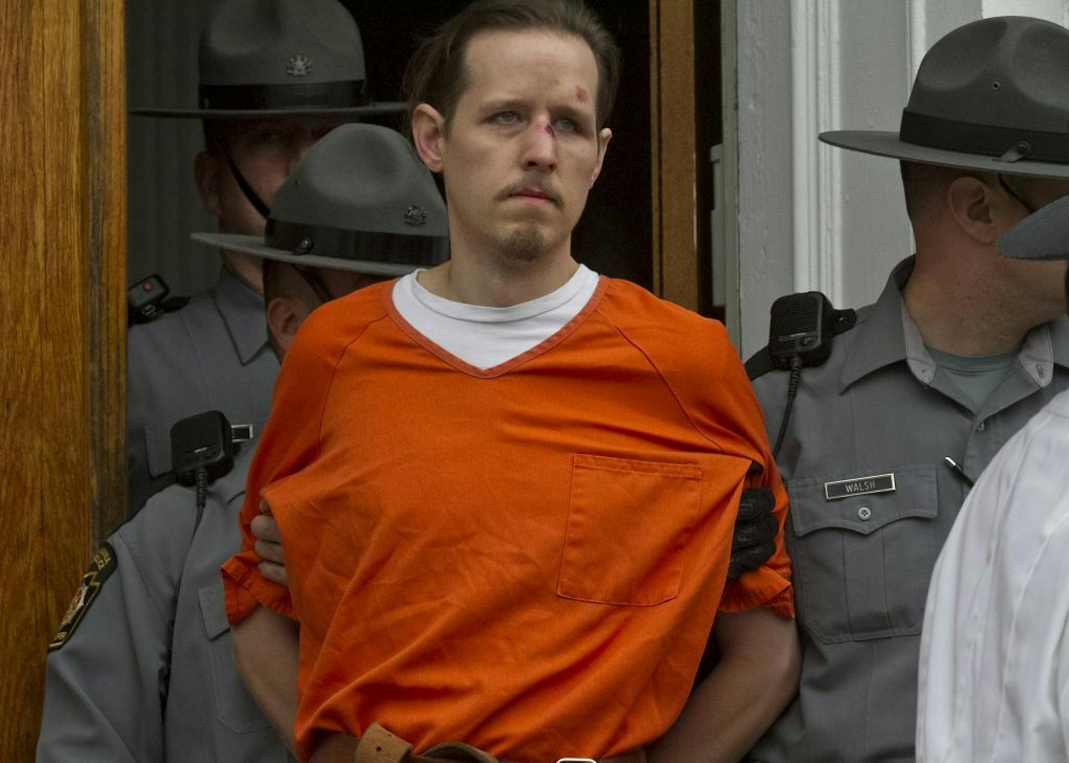 Eric Frein, charged with murder of Pennsylvania State Trooper Cpl. Byron Dickson and critically wounding Trooper Alex Douglass Sept. 10, is taken to prison after a preliminary hearing in Pike County Courthouse on Friday, Oct. 31, 2014 in Milford, Pa.