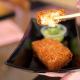 Two hash browns with ginger scallion sauce.