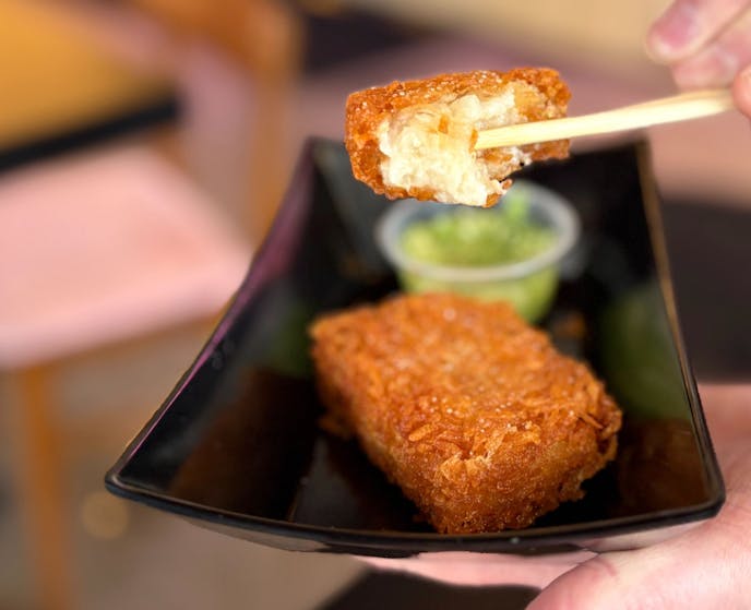 Two hash browns with ginger scallion sauce.