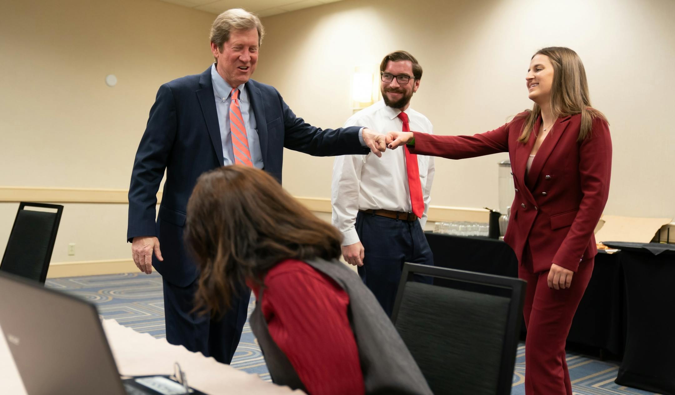 Jason Lewis fist bumped campaign manager Tom Szymanski and communications director Christine Snell in his war room before he spoke at the Election Night Party at the DoubleTree Hotel in Bloomington.