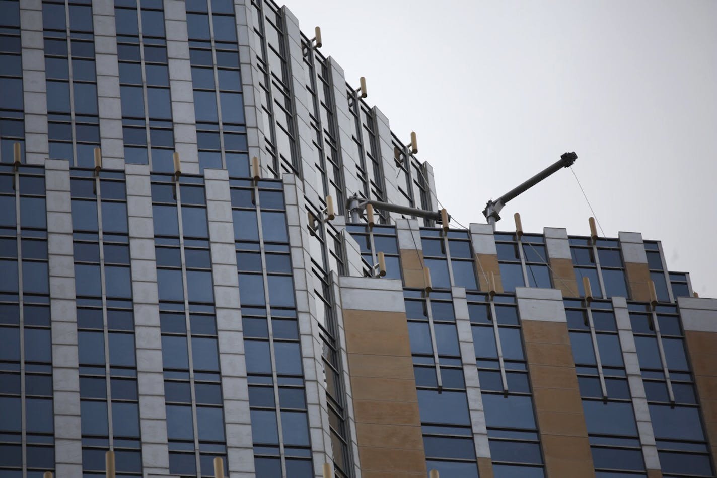 Equipment is visible high on the Wells Fargo Center building in downtown Minneapolis after a technical rescue of window maintenance workers from the 52nd floor on Wednesday, July 8, 2015.