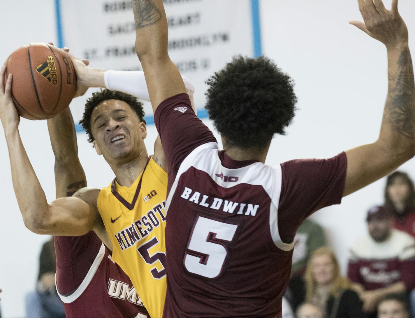 UMass forward Chris Baldwin, right, guards Minnesota guard Amir Coffey (5) during the first half of an NCAA college basketball game, Friday, Nov. 24, 2017, in New York. (AP Photo/Mary Altaffer)