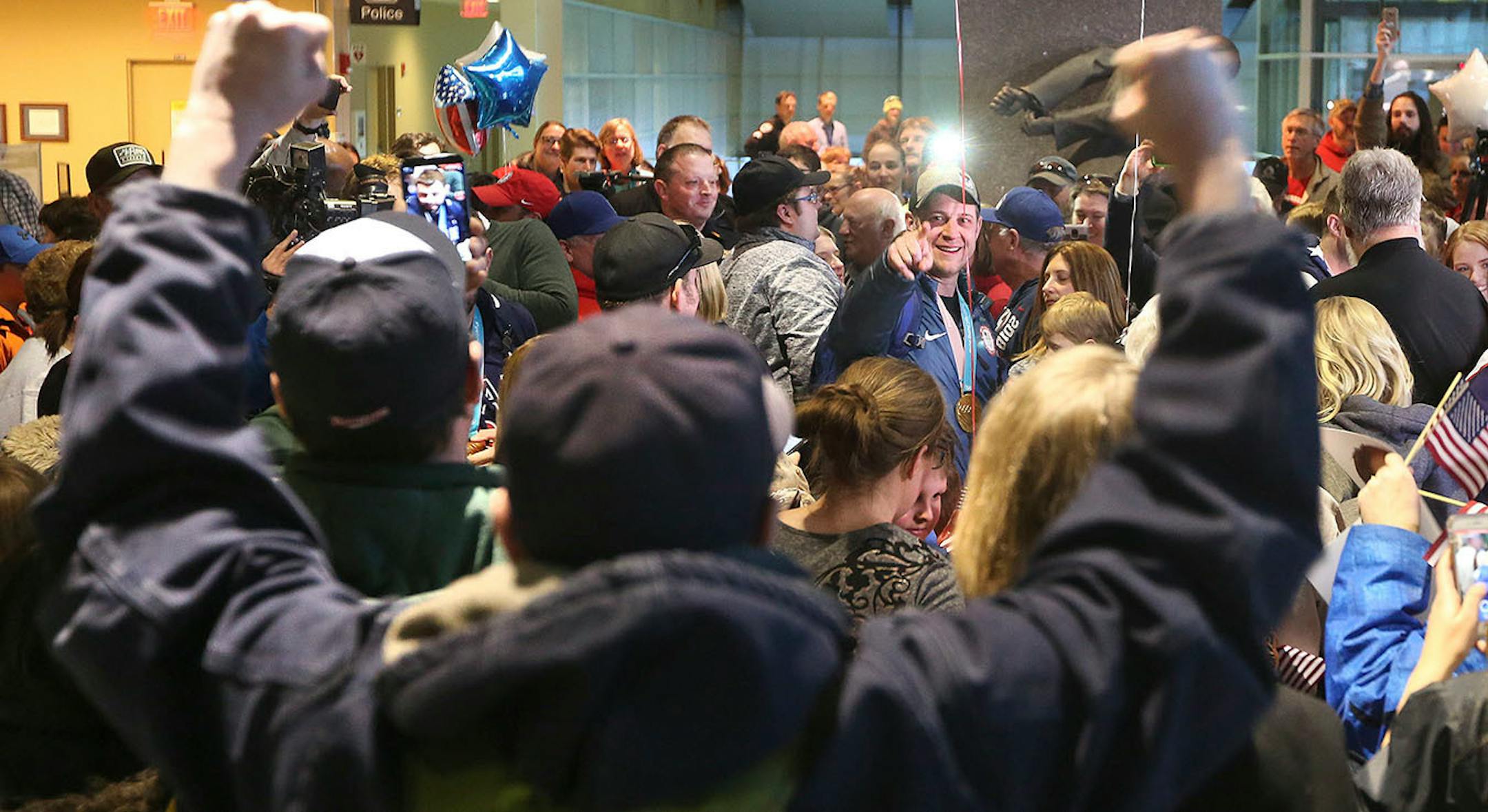 A well-wisher cheers on John Shuster (right of center) as Shuster points back to notice and thank him. Bob King / rking@duluthnews.com