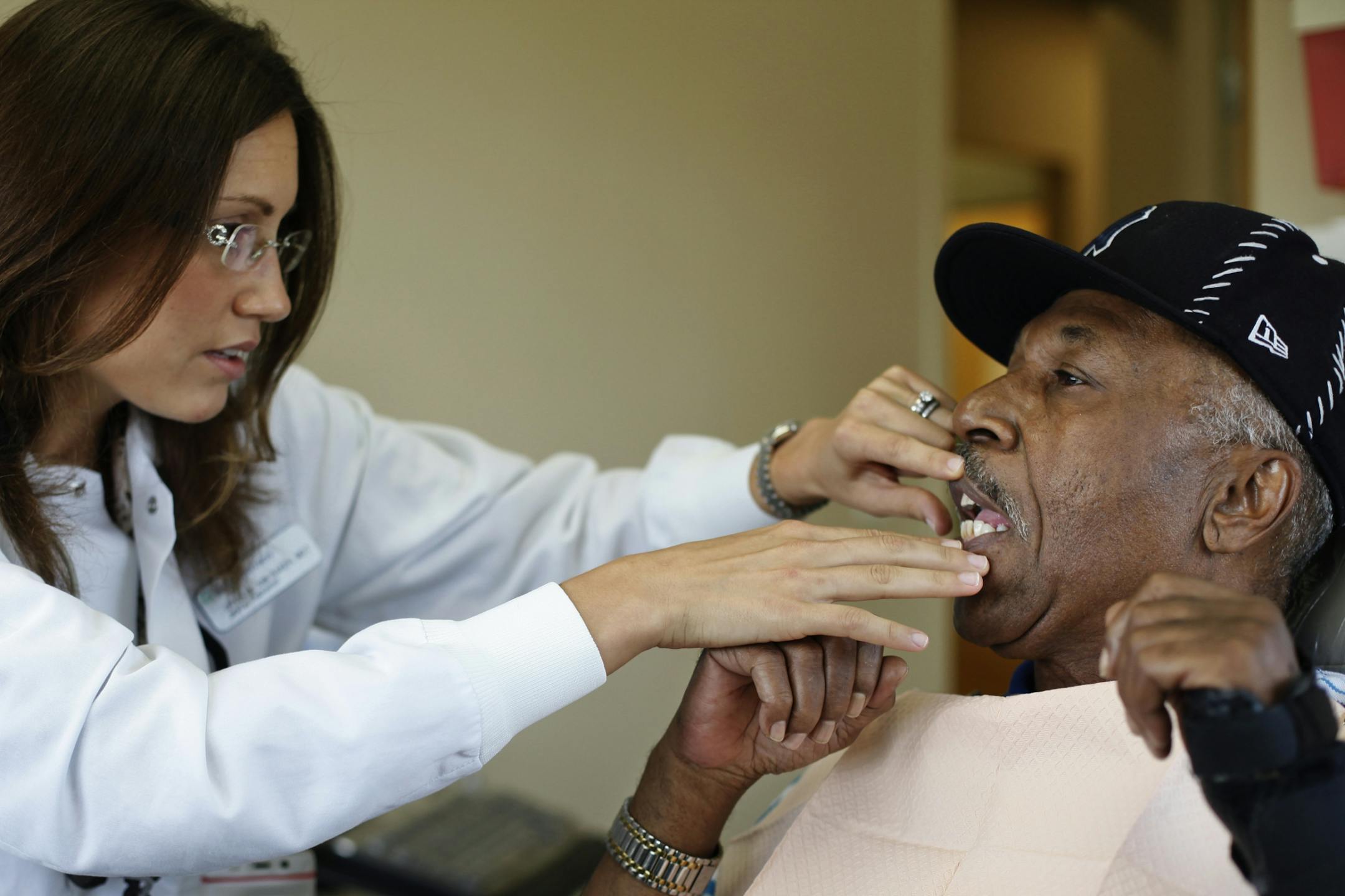 After a two fillings, Crystal Ann Baker, one of the state's first dental therapists does a final check of Donald Roland's teeth at Midway Dental Clinic in St. Paul, Minn. on Thursday, July 12, 2012.