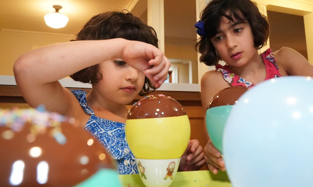 Kiran Thammon, 7, and Divya Thammon, 9, dipped balloons in melted chocolate and added sprinkles.