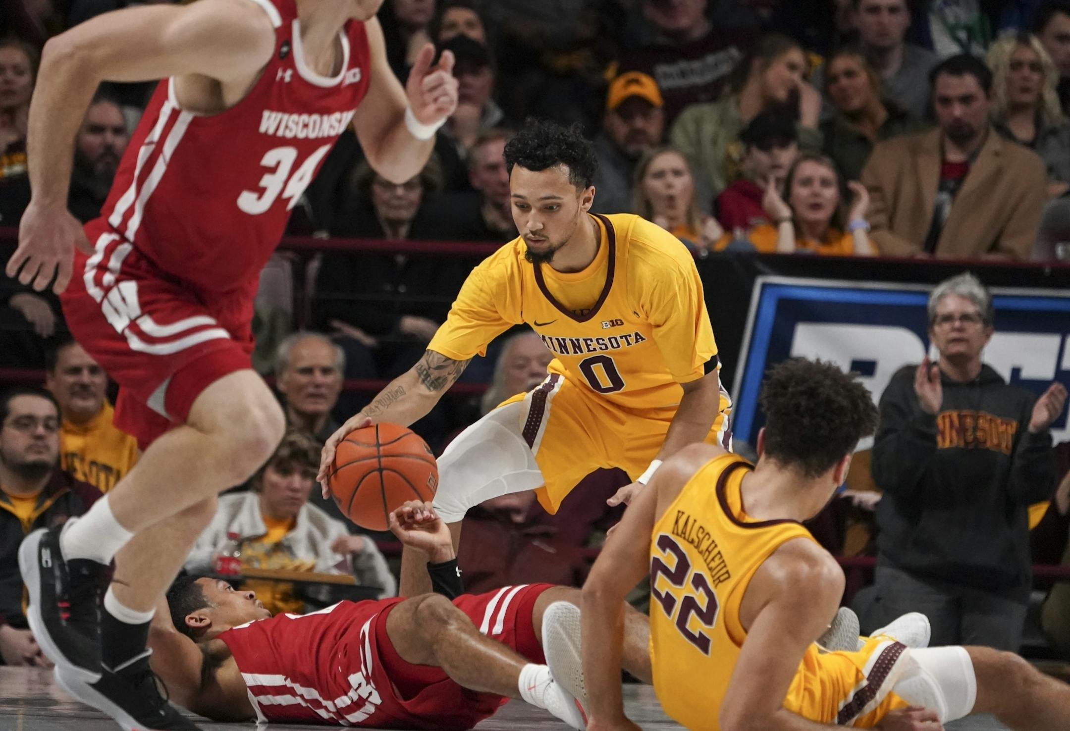 Minnesota Gophers guard Payton Willis (0) grabbed the loose ball after Wisconsin Badgers guard D'Mitrik Trice (0) tripped and lost it in the first half.