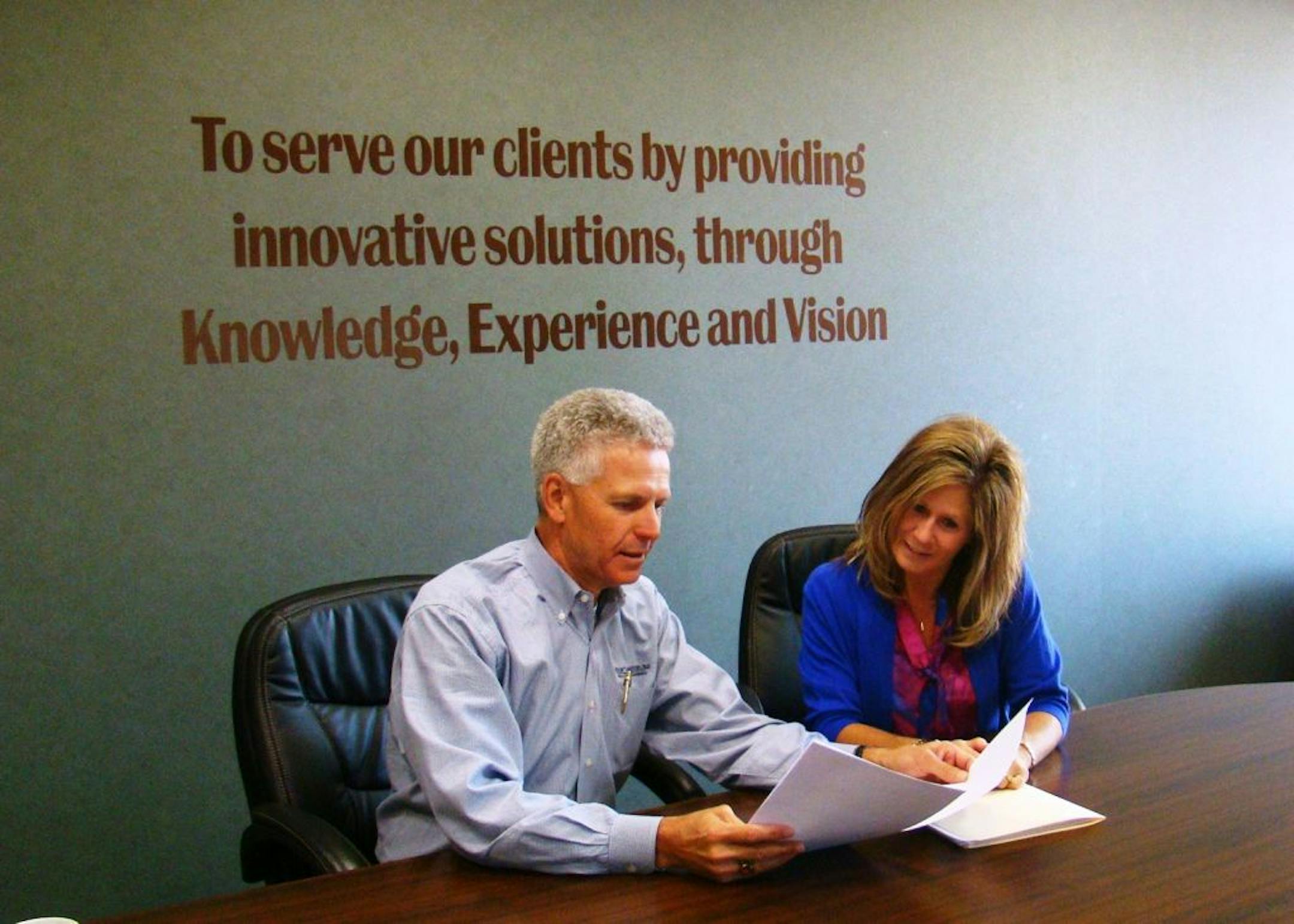 John Christianson, left, is principal partner in Willmar, Minn.-based Christianson & Associates, an accounting and consulting firm that has created a fee-based service to track the efficiency and performance of ethanol plants. The service, called Biofuels Benchmarking, is managed by Paula Emberland, right. It offers ethanol plant clients a way to measure their efficiency, which has become critically important as operating margins are pinched by high corn prices. Credit: Sandy Holtberg, Christian