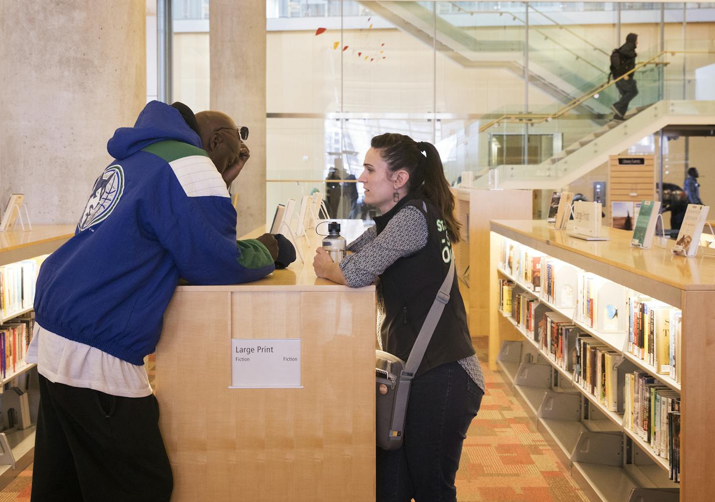 Outreach coordinator Kate Coleman, right, meets with Byron Brooks about his housing issues at the library. ] LEILA NAVIDI &#xef; leila.navidi@startribune.com BACKGROUND INFORMATION: Kate Coleman works as Minneapolis Central Library's outreach coordinator on Tuesday, March 21, 2017. Hennepin County Libraries are adding a full-time social worker through St. Stephen's that will help with homeless people in the downtown library. The library has been beefing up the services it provides homeless peopl