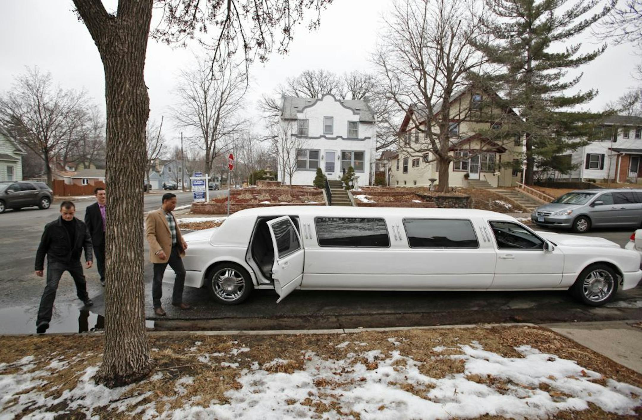 After checking out a listing in Southwest Minneapolis, agent Ryan Kempenich, center, and clients John, left, and Rich Goettl, head back to Kempenich's limo Friday, Feb. 3, 2012, in Minneapolis, MN.