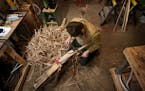 Maxwell Kelsey, 34, a wooden lacrosse stick maker, uses a piece of ash that he split from a log to shape into a stick Monday, March 27, 2017, in Bemid