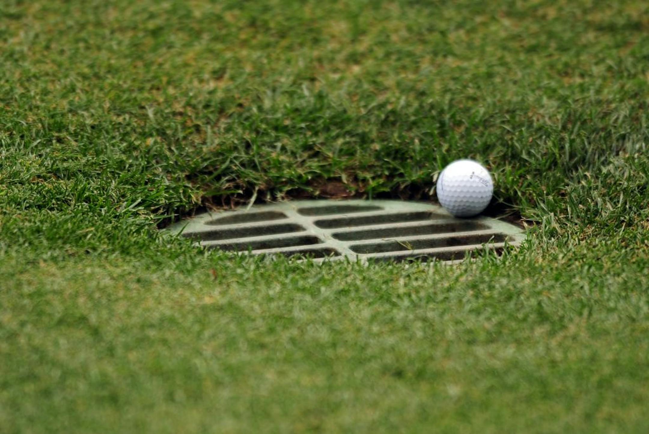 Bill Haas' golf ball comes to stop on a storm grate along the 10th fairway during the second round of the Wells Fargo Championship at Quail Hollow Club, Friday, May 6, 2011, in Charlotte, North Carolina.