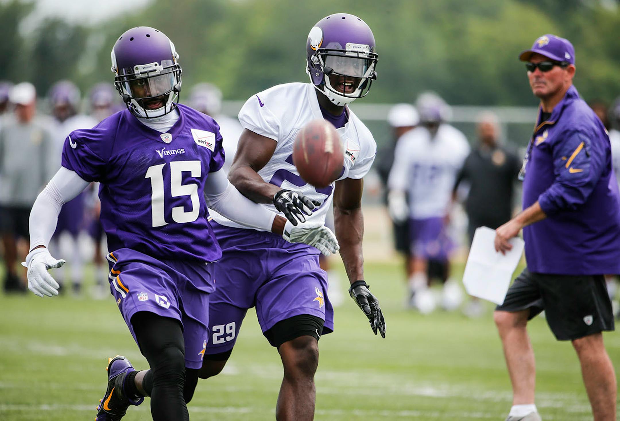 Minnesota Vikings receiver Greg Jennings (15) and safety Xavier Rhodes (29) battle for a pass during training camp Friday, July 24, 2014, at Minnesota State in Mankato, MN.