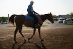 Trainer Tony Rengstorf rides a pony from the track at Canterbury Park in Shakopee in May.