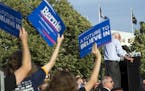Supporters hold-up campaign signs as Democratic presidential candidate Sen. Bernie Sanders, I-Vt., speaks at a rally in Washington, Thursday, June 9, 