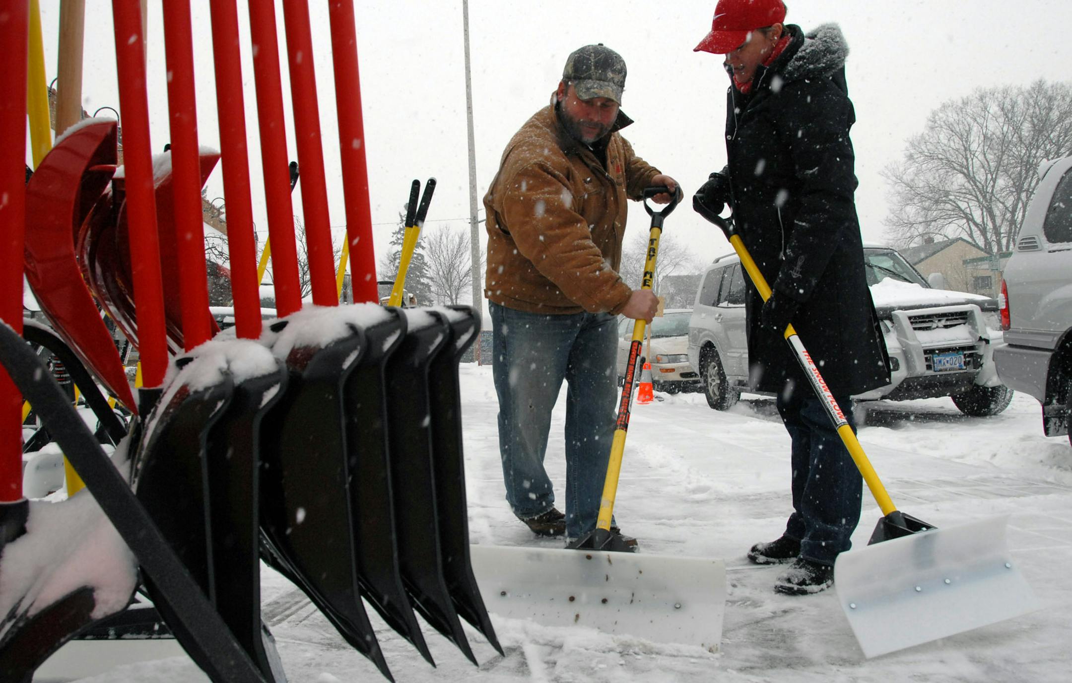 JOEY MCLEISTER ï jmcleister@startribune.com Minneapolis,Mn.,Sat.,Dec. 1, 2007--(Left to right) Bob Knaak, manager of Settergren Ace Hardware at 54th and Penn Av. helped Cynthia Henry of Minneapolis with his "best seller" a 24-inch Snow Plow shovel as the snow started in earnest.