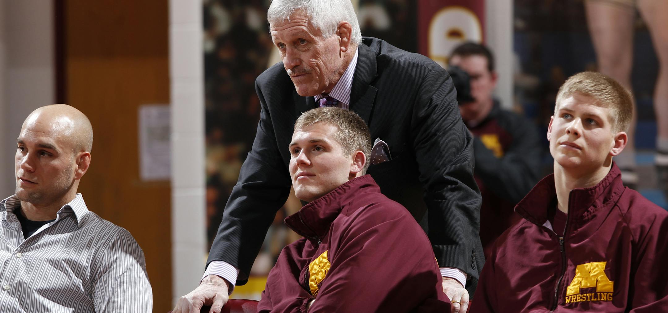 Logan Storley, sitting in front of coach J Robinson, has earned All-America honors three times for the Gophers. “The goal is absolutely to win a national title,’’ Storley said.