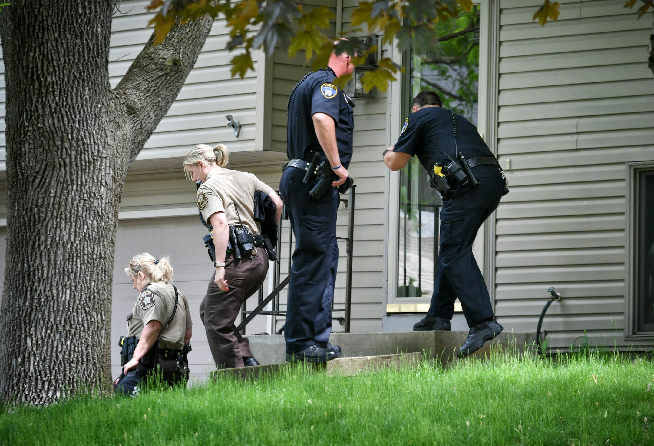 Eden Prairie Police and Hennepin County Sheriff's investigators talked with neighbors down the street from a home where two adults were found dead Thursday morning. ] GLEN STUBBE • glen.stubbe@startribune.com Thursday May 25, 2017 Eden Prairie Police and Hennepin County Sheriff's office investigated a crime scene in Eden Prairie where two adults were found dead Thursday morning. A person of interest was arrested a few hours later. The address was 6770 Woodhill Trail, Eden Prairie. EDS: Ne