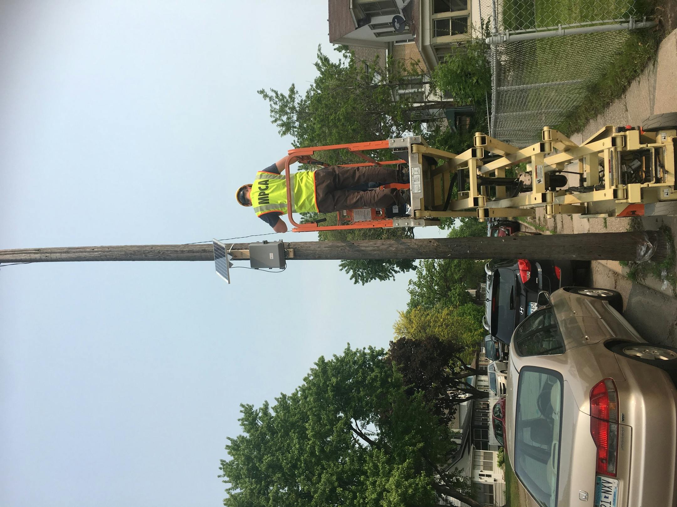 MPCA employee Jake Nelson installs an air pollution monitor.