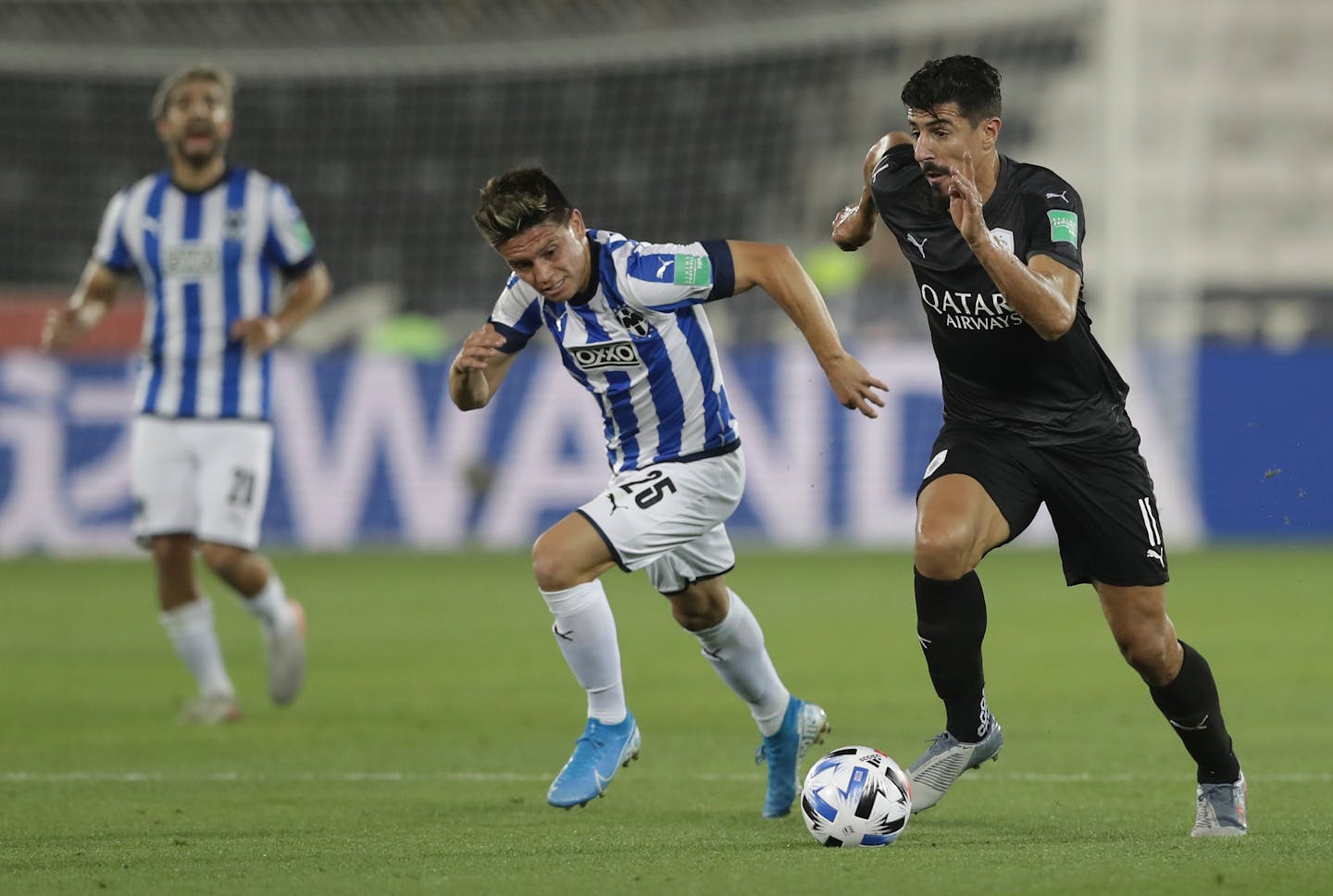 Monterrey's Jonathan Gonzalez, left, and Al-Sadd's Baghdad Bounedjah run or the ball during the Club World Cup soccer match between Monterrey and Al-Sadd at Jassim Bin Hamad Stadium in Doha, Qatar, Saturday, Dec. 14, 2019. (AP Photo/Hassan Ammar)