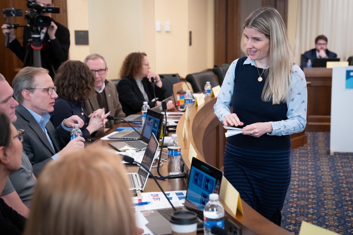 Lindsey Dyer of the Minnesota Historical Society collected ballots for the final design and delivered results to the committee chair as Minnesota's flag commission picked a final flag design Tuesday in St. Paul.