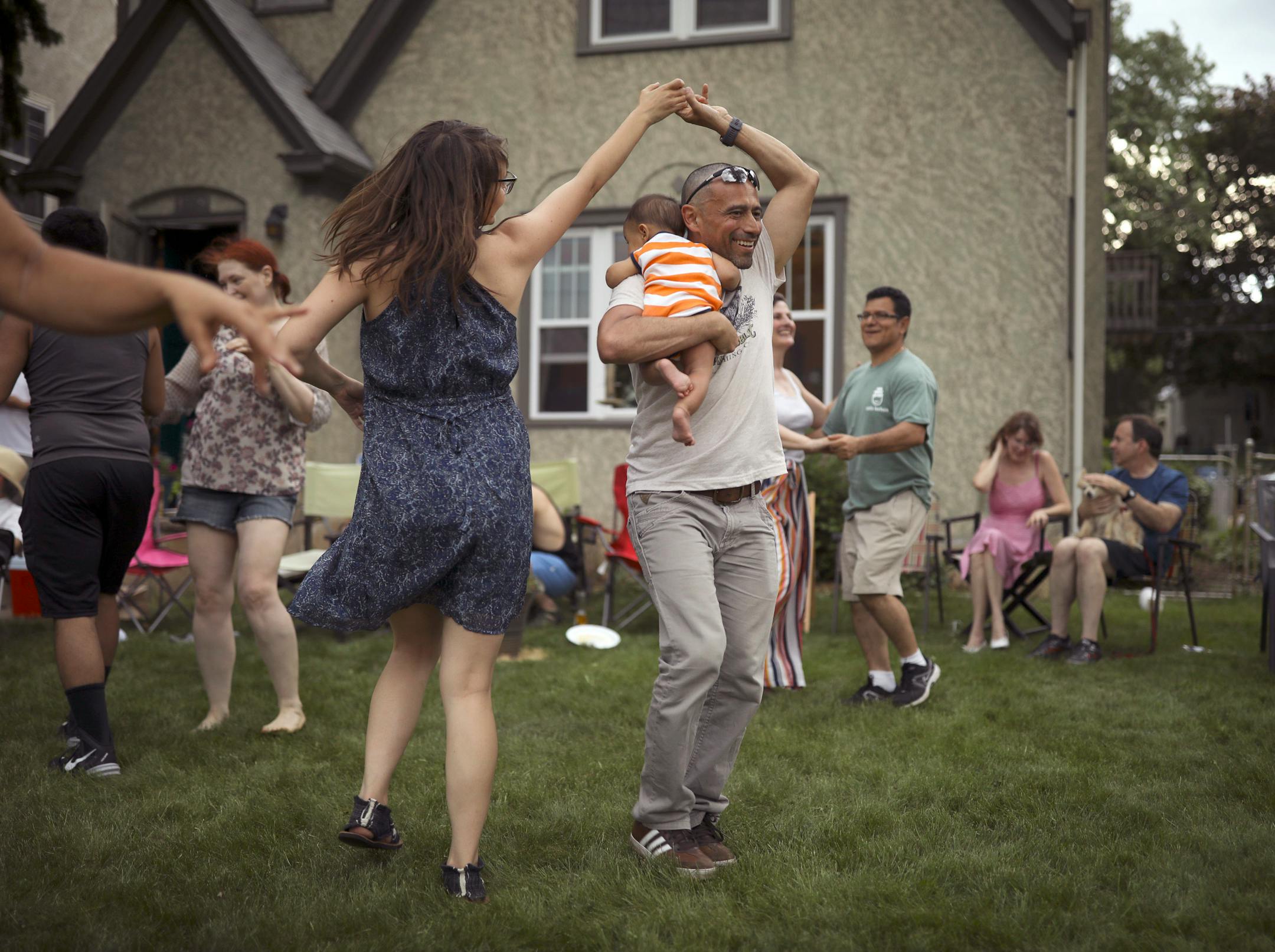 A crowd of friends, including Maria Schwedhelm and Sandro Rios, holding their son, Ilan, danced Afro Cuban style on Stephanie Owen's front yard on 28th Ave. S. Monday afternoon. Earlier in the day they had been across the street at Lake Hiawatha Park, but when rain threatened they moved the party to the front yard. "The first of many Memorial Day parties," Owen said.