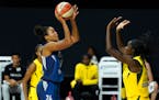 Minnesota Lynx forward Napheesa Collier (24) shoots in front of Seattle Storm center Ezi Magbegor (13) during the first half of Game 3 of a WNBA baske