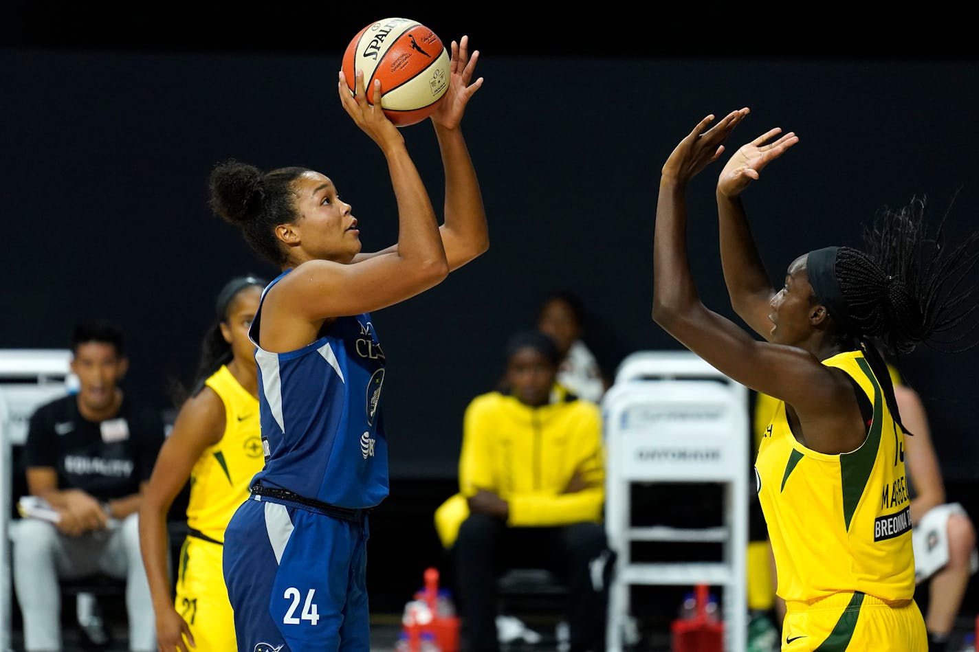 Minnesota Lynx forward Napheesa Collier (24) shoots in front of Seattle Storm center Ezi Magbegor (13) during the first half of Game 3 of a WNBA basketball semifinal round playoff series Sunday, Sept. 27, 2020, in Bradenton, Fla. (AP Photo/Chris O'Meara)