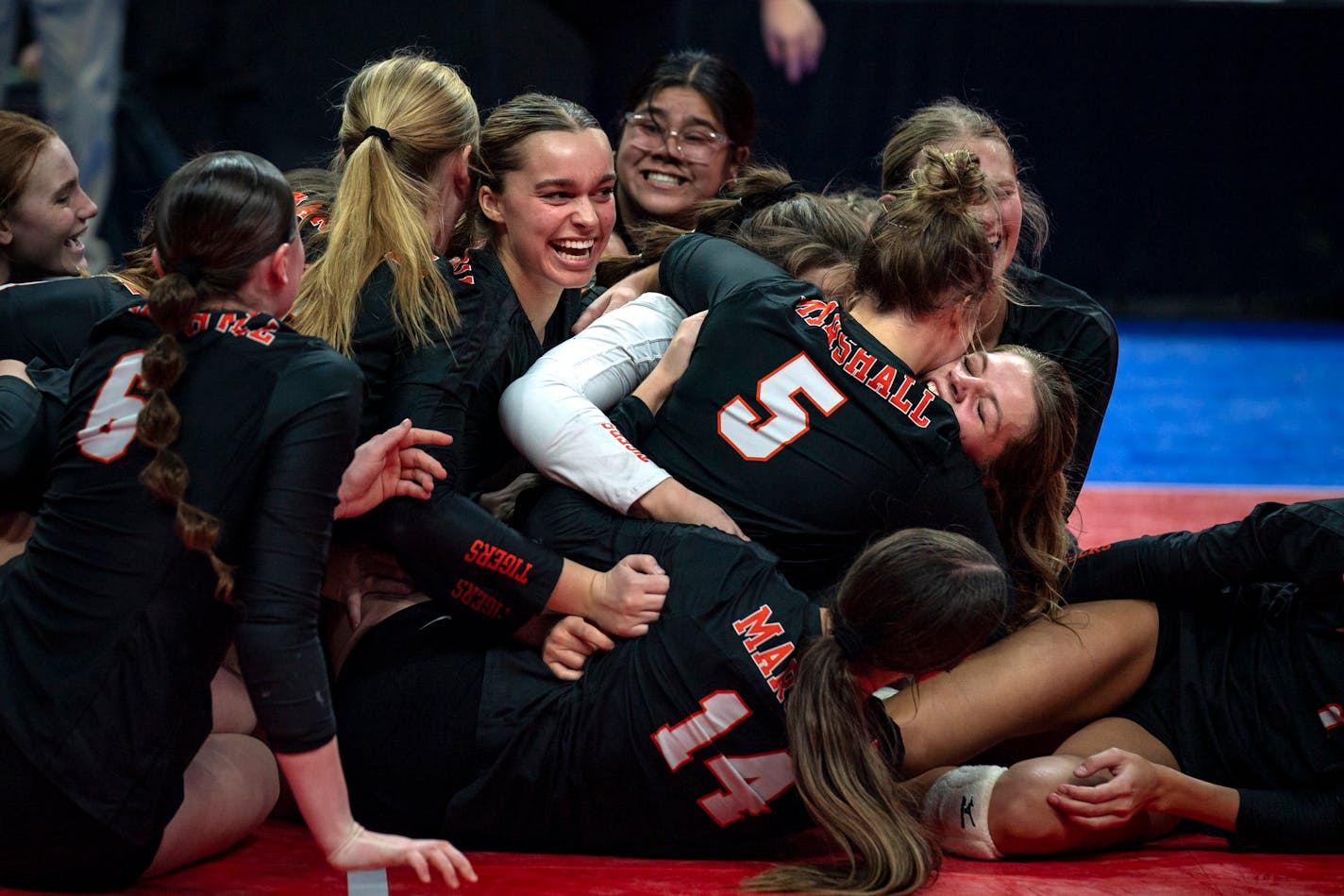 Marshall High School volleyball teammates celebrate after their 3-0 win against Delano High School at the Class 3A Volleyball State Championship match at Xcel Energy center in St. Paul Minn. on Saturday, Nov. 11, 2023. ] Angelina Katsanis • angelina.katsanis@startribune.com