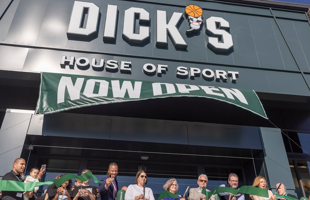 Former NFL player Larry Fitzgerald, center left, joined others to cut the ribbon at the new Dick’s House of Sport store at Ridgedale Center in Minnetonka on Friday.