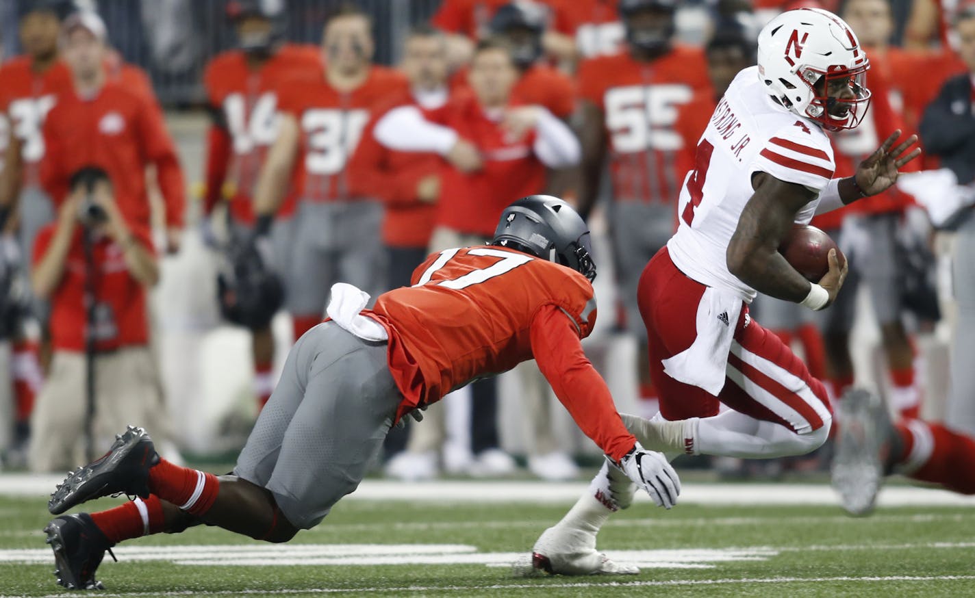 Nebraska quarterback Tommy Armstrong, right, is chased by Ohio State linebacker Jerome Baker during the first half of an NCAA college football game Saturday, Nov. 5, 2016, in Columbus, Ohio. Armstrong was injured on the play and left the stadium in an ambulance. (AP Photo/Paul Vernon) ORG XMIT: OHJL116