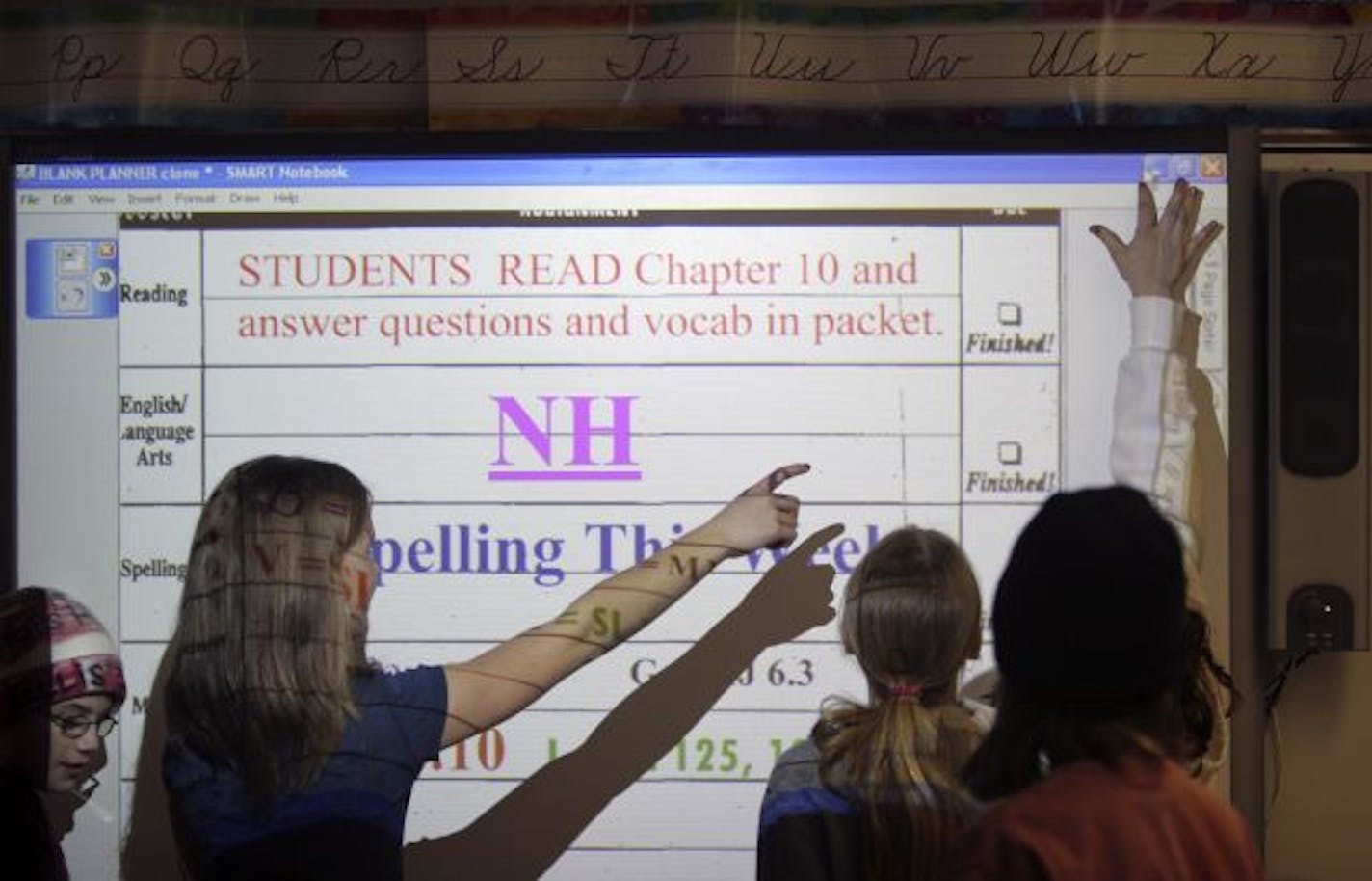 THOMAS WHISENAND*twhisenand@startribune.com 02/21/2007----- Fifth graders at Centerville Elementary School in Centerville, Minn., used an interactive white board during class on Wednesday, February 21. The boards work much like a large touchscreen computer allowing the user to write notes electronically and save lessons for the next day's class. // schools, education, students, teachers //