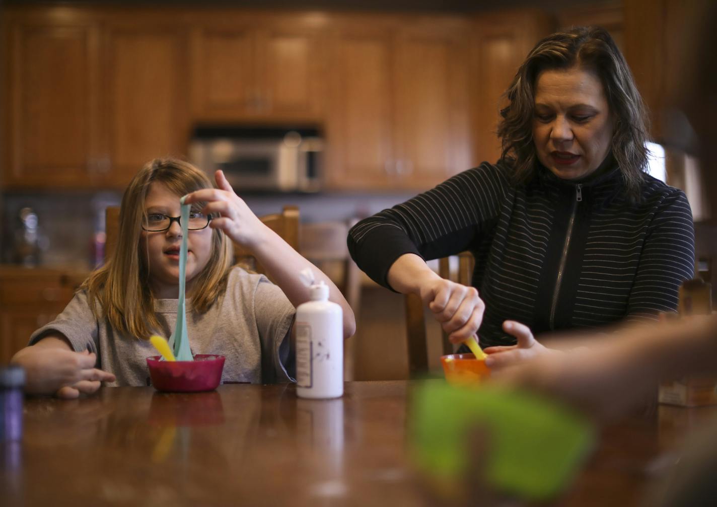 Hadley Lucca and her mom, Sarah, each mixed up a batch of slime, along with Hadley's twin, Clara, foreground. ] JEFF WHEELER &#x2022; jeff.wheeler@startribune.com Hadley Lucca, 11, took part in a groundbreaking study at the University of Minnesota, where researchers found that target electrical currents helped improve coordination and motor skills in children with cerebral palsy. Hadley and her twin sister, Clara, spent a portion of their snow day Monday, March 5, 2018, teaching their mom, Sarah